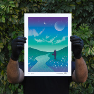 Someone holding a blue and green landscape illustration print by mariana PTKS