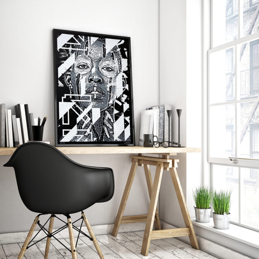 Black and white illustration print by Samina on a frame over a desk.