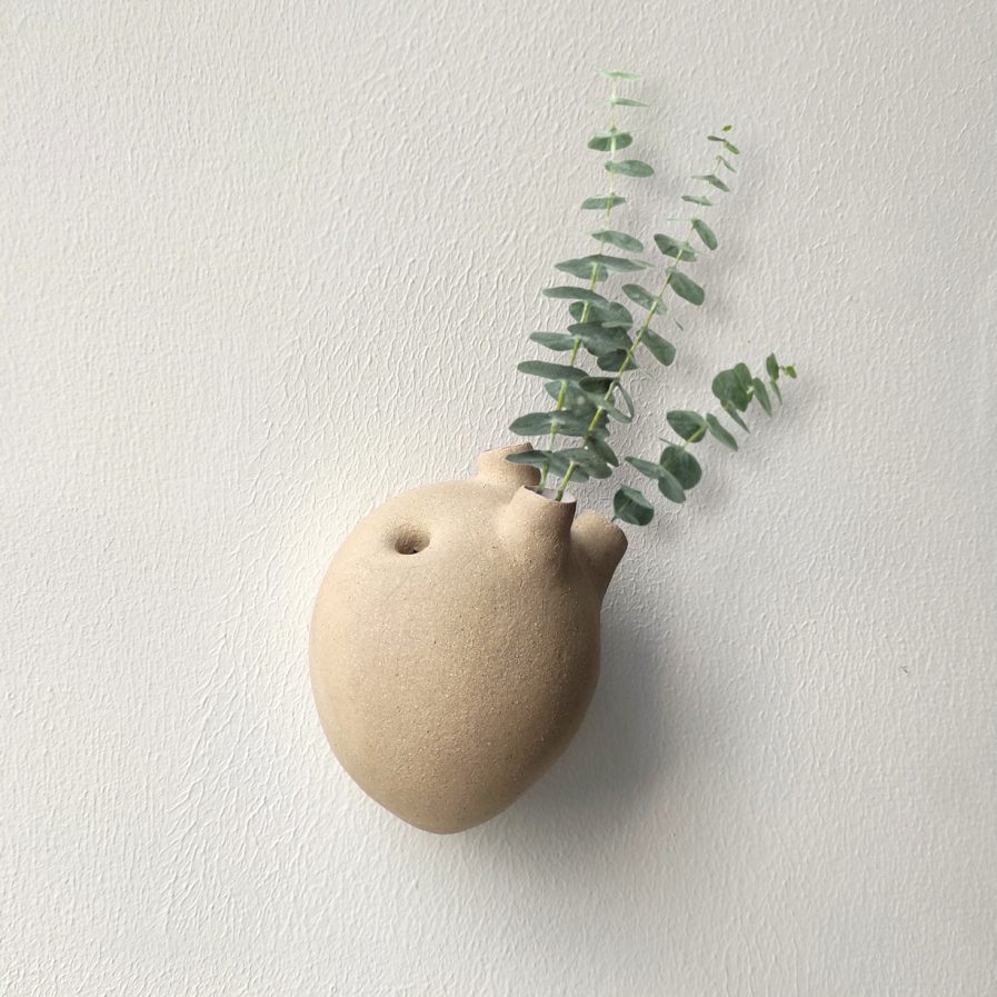 ceramic heart with plants on the wall